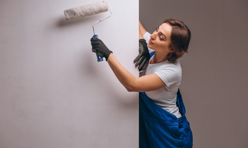 Woman repairer with painting roller isolated