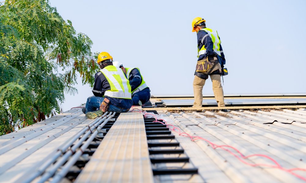 workers installing solar panels, for efficient energy on rooftop